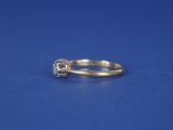 a close up of a diamond ring on a blue surface