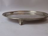 an antique silver plate on a stand on a white background