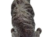 a statue of a bear sitting on the ground