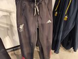 three pairs of pants hanging on a rack in a clothing store
