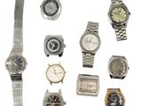 a lot of watches that are sitting together on a white surface
