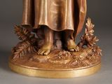 a statue of a man holding a bird in his hand