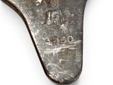 a silver spoon with a horse on it on a white surface