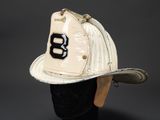an old fireman ' s helmet with the number 8 on it