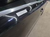 a picture of a car door handle with a sticker on it