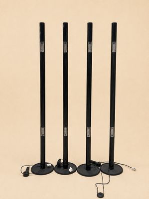 a set of three black speakers sitting on top of a table