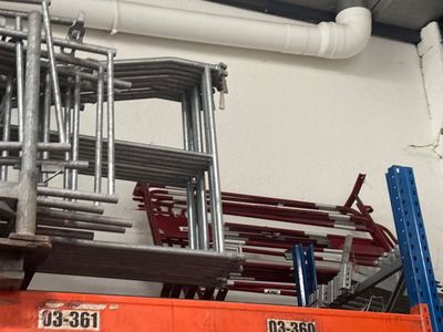 many chairs and ladders in the room of a building