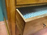 a wooden cabinet with a drawer on top of it