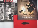 deux livres posés sur une table, à côté d'un dossier rouge
