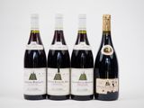 quatre bouteilles de vin sont alignées sur une surface blanche