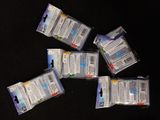 several packages of toothpaste sitting on top of a black table