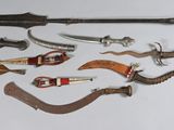many different types of weapons displayed on a white surface