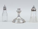 three salt and pepper shakers sitting next to each other