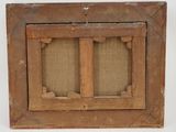 an old wooden window frame with two small windows on the inside