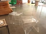 two clear stools sitting on the floor in a living room