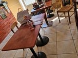 tables and chairs in a room with a lot of papers on the floor