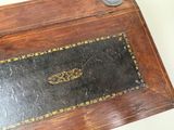 a small wooden box with a coin on top of it