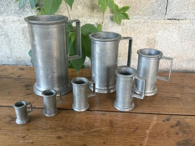 a group of metal items sitting on a wooden table