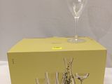 a box of wine glasses sitting on a table