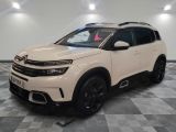 une Citroën blanche garée dans une pièce au sol carrelé