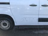 a white van that has holes in the side of it