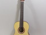 a guitar that is sitting on a table next to a book