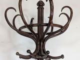 a coat rack that has a bunch of hooks on it