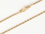 a close up of a gold chain on a white background
