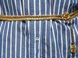 un gros plan sur la ceinture d'une femme ornée d'une chaîne en or