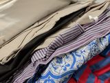 a pile of clothes sitting on top of a table