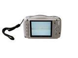 a digital camera that is sitting on a white surface