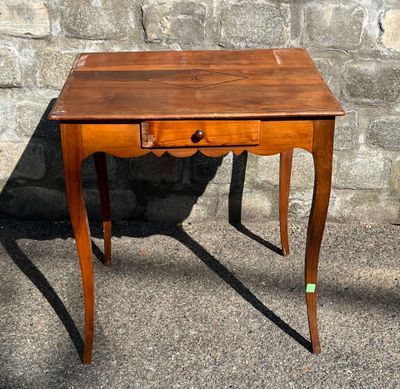 a small wooden table with a drawer on top of it