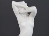 a white statue of a woman holding her head in her hands