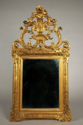 an ornate gold framed mirror with a black background