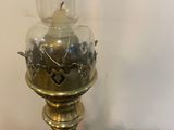 a close up of a lamp on a table next to other items