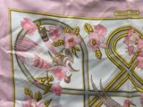 a pink scarf with a picture of a bird and a dragon on it