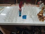 many glasses and bottles on a table with a blue sticker