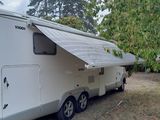 an image of a camper trailer parked in a field