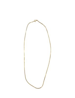 a gold necklace with a long chain and a clasp on a white background