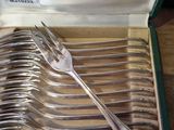 a lot of forks in a box on the table