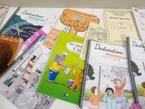 several children ' s books are lined up on a white table