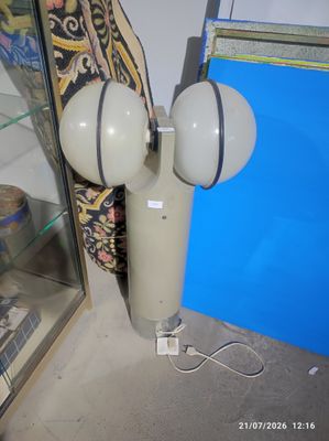 une lampe posée par terre devant une vitrine