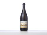 the bottle of wine is sitting on a table with a white background