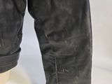 a close up of a pair of black leather boots with a white background