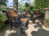 three wooden benches sitting next to each other in a park