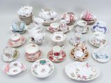 many different types of tea cups and saucers on the table