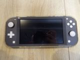 a person taking a picture of a nintendo wii game system