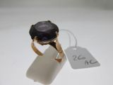 an image of a ring with a purple stone on it