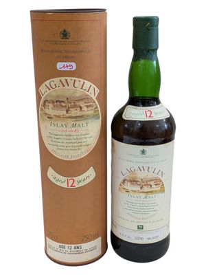 a bottle of whisky sitting next to a cardboard box