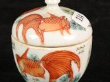a small bowl with a lid that has a picture of a cat on it